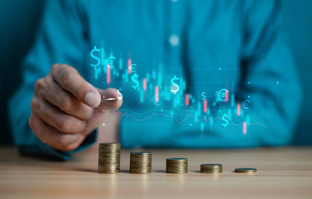 Stacked coins and financial chart visualizing the concept of setting financial goals