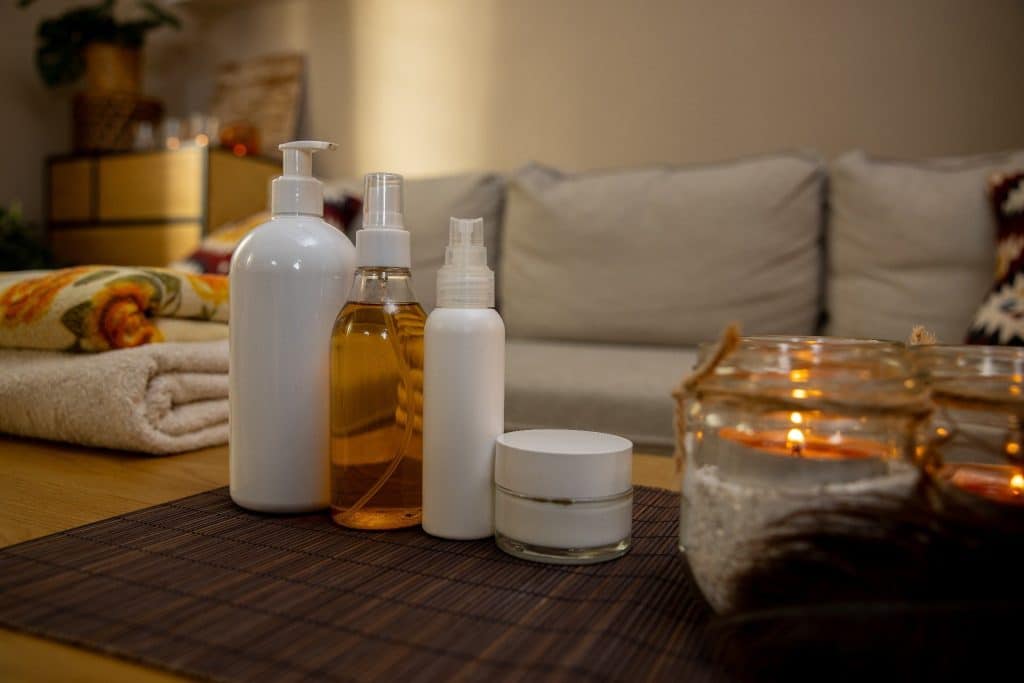 Home spa setup with candles and skincare products as part of affordable staycation ideas.