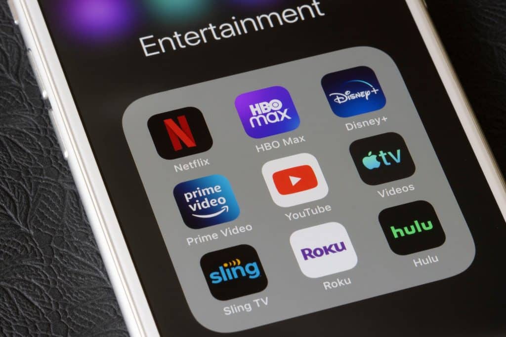Smartphone screen showing multiple streaming apps affecting managing monthly budget.