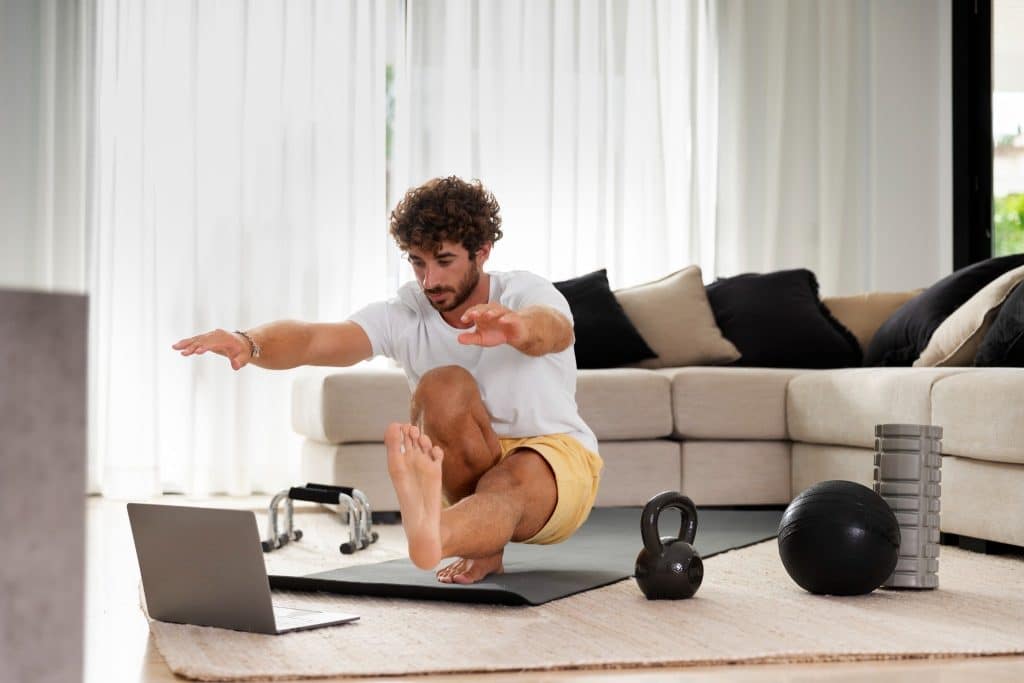 A person working out at home, showing that managing personal finances can also involve taking control of your lifestyle to save on monthly expenses.