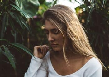woman near green leafed plants