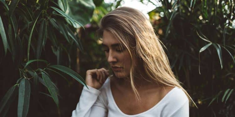 woman near green leafed plants