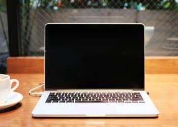 laptop computer beside coffee mug