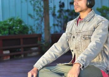 a man sitting on a table wearing headphones
