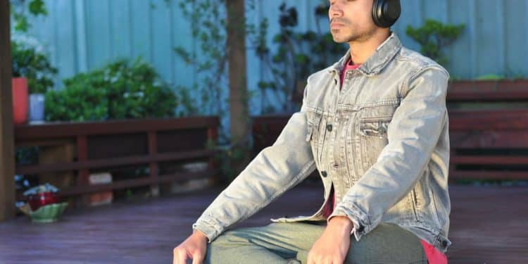 a man sitting on a table wearing headphones