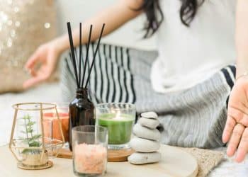woman in white tank top holding black chopsticks