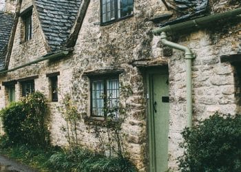 white and brown concrete house near trees at daytime