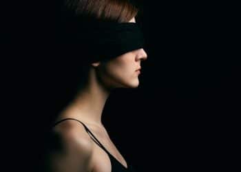 woman wearing black blindfold facing sideways