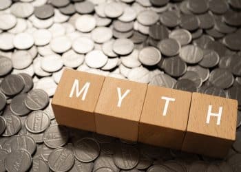 Changing money mindset by breaking financial myths concept with wooden blocks.