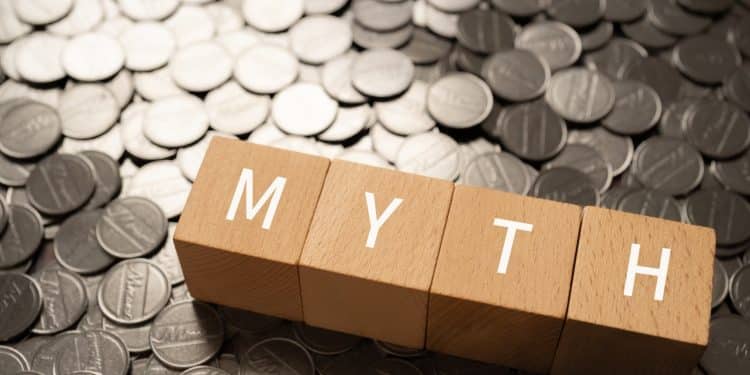 Changing money mindset by breaking financial myths concept with wooden blocks.