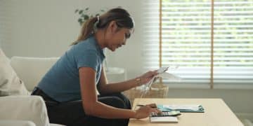 Woman focused on her own finances at home, practicing healthy money habits.