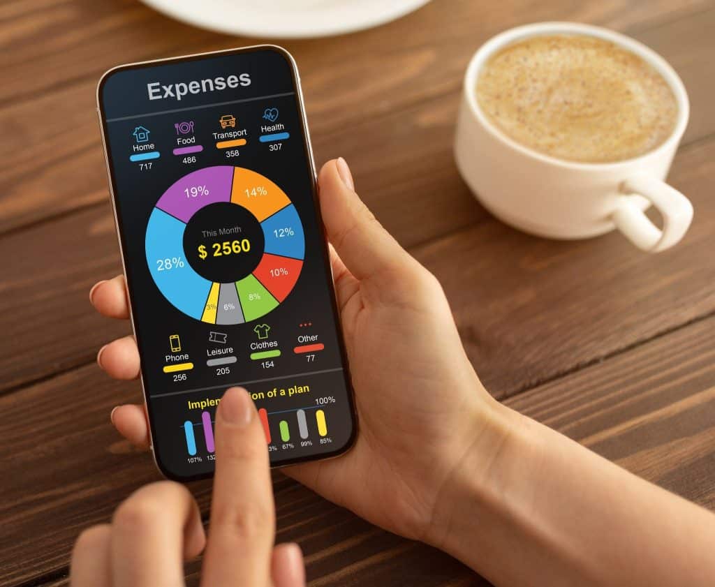 Person using a mobile budgeting app to track expenses as part of realistic financial advice practices.