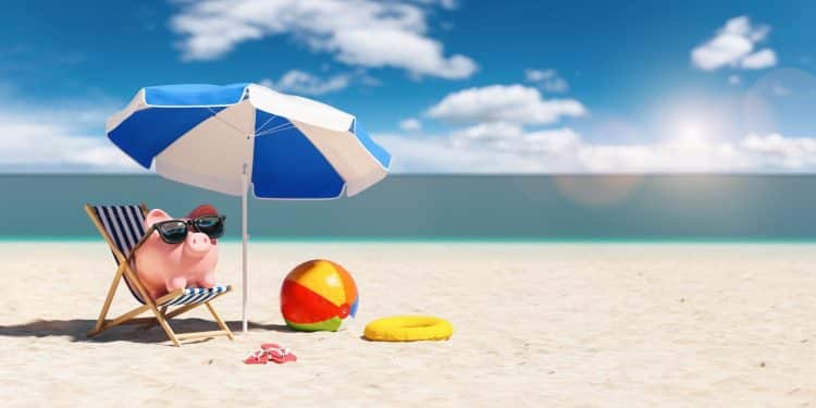 Piggy bank relaxing on a beach chair – travel budget tips for saving money on vacations.